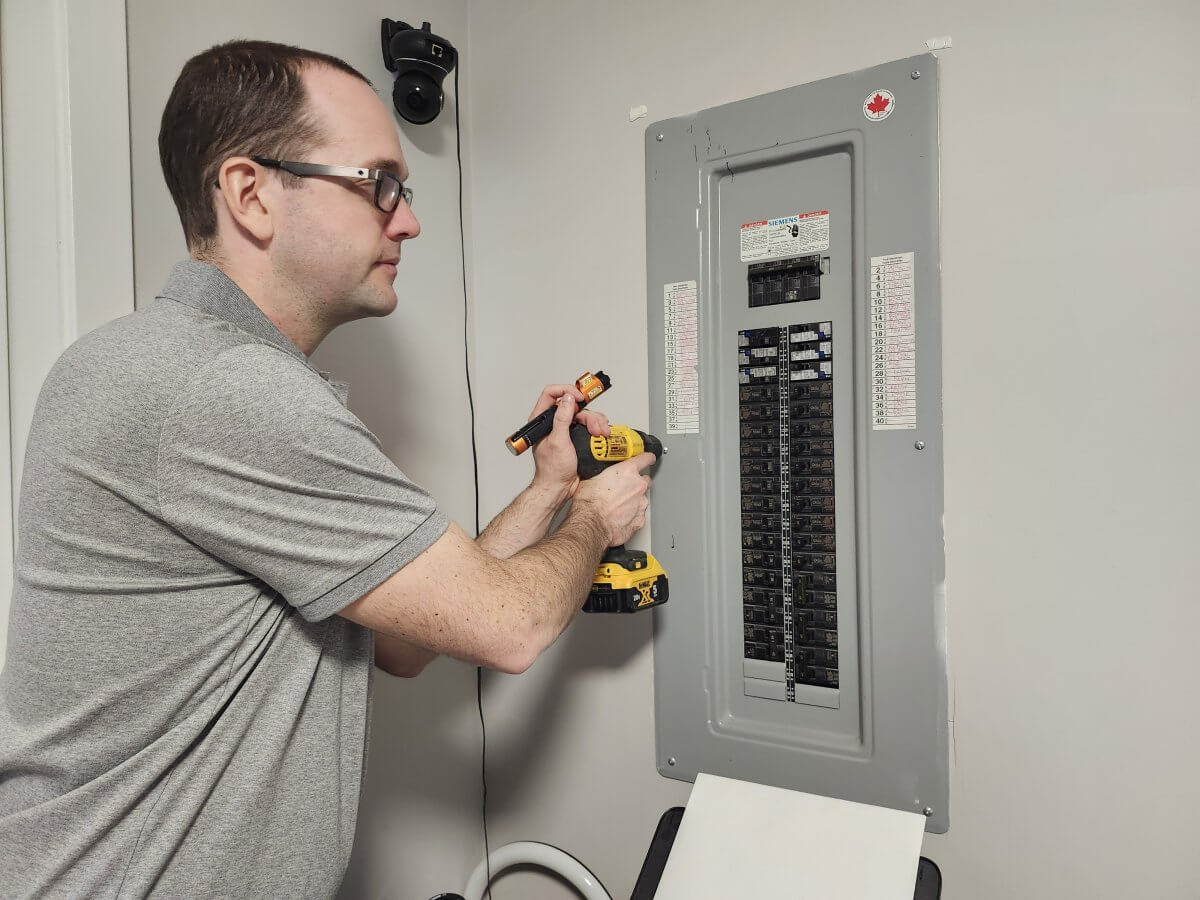 At Ease property Inspections reviewing an electrical panel for any potential concerns around breakers or wiring for electricity concerns in Kelowna and Central Okanagan