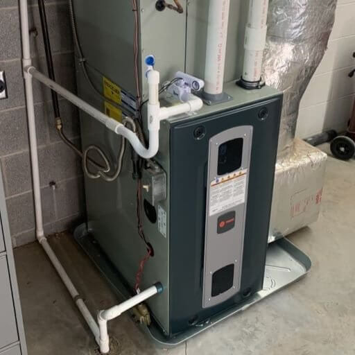 Indoor HVAC system featuring a gas furnace and an air conditioning unit (evaporator coil) installed in a utility room or basement. The system includes ductwork, electrical wiring, and condensate drainage, all working together to heat and cool the home. Regular maintenance of both the furnace and AC components ensures efficient operation, improved indoor air quality, and consistent year-round comfort. Erich with At Ease Property Inspections consistently checks for leaks and any signs of concern with the interior units 